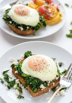 two white plates topped with toast and an egg on top of it next to a fork