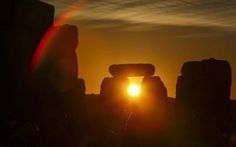 the sun is setting over stonehenge in england