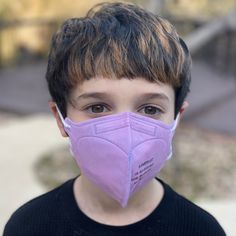 The only 100% American-Made KN95 for kids. Our USA-Made KN95 kids masks are not just constructed in the US with 100% American-made materials, they're also produced in a FDA-registered facility that produces NIOSH Approved N95 masks alongside them. KN95 masks are an incredibly popular respirator design. The cone shape provides a tighter seal than surgical masks, while many find the ear loops more comfortable then the head straps found on traditional cup-style N95 masks. It's a good design, but af Kn95 Mask, Kids Packaging, Purple Cases, Pink Mask, Wide Face, N95 Mask, White Mask, Purple Bag, Grey Bag