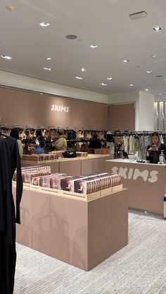 a woman standing in front of a store filled with women's clothing and shoes