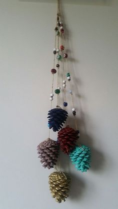 several pinecone ornaments hanging on a wall