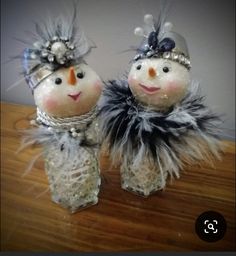 two snowmen are standing next to each other