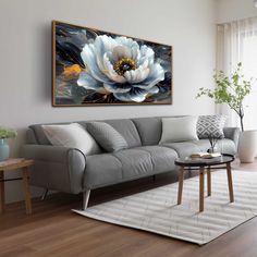 a living room with a couch, coffee table and painting on the wall above it