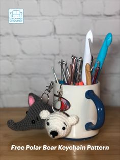 a cup filled with office supplies on top of a wooden table