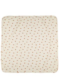 a blanket with brown dots on it