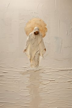 a person walking in the water with an umbrella over their head and wearing a white outfit