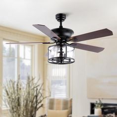 a ceiling fan in a living room with windows