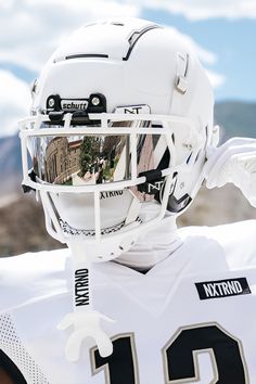 a football player wearing a white uniform and helmet