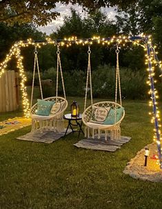 an outdoor swing set with lights on it