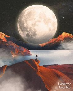 a man standing on top of a mountain next to a lake under a full moon