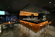 a bar with several stools in front of it