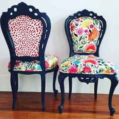 two chairs with floral upholstered back and arms on wooden floor next to wall