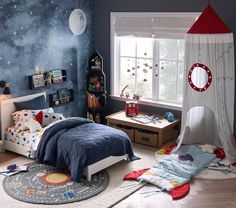 a child's bedroom decorated in space themed decor