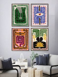 three paintings hang on the wall in a living room