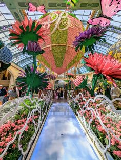 the inside of a flower shop filled with lots of flowers