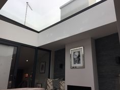 a living room filled with furniture and a skylight