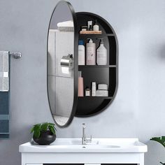 a bathroom sink sitting under a mirror next to a shelf