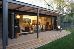 an outdoor living area with wooden decking and sliding glass doors