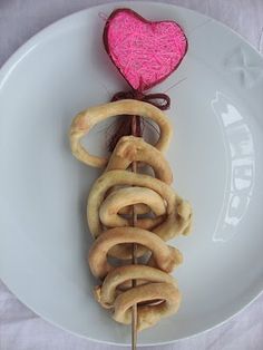 a white plate topped with pretzels and a pink heart