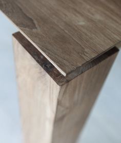 a close up of a wooden object on a white surface