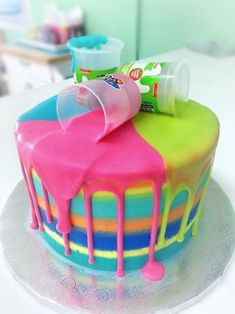 there is a colorful cake with icing on it