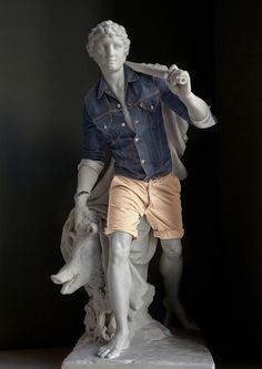 a statue of a man with a wolf on his shoulder and a denim shirt over his shoulders