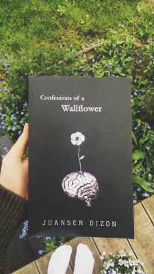 someone holding up a book in front of their face with the title'conversations of a wallflower '