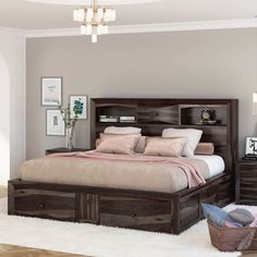 a bedroom with a bed, nightstands and pictures on the wall above it in a neutral color scheme