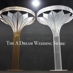 two white and gold lamps on display with the words the a dream wedding store