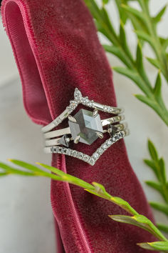 a close up of a ring on top of a red cloth