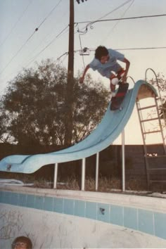 a man riding a skateboard down the side of a slide