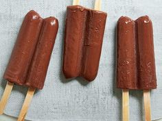 three hotdogs on sticks with toothpicks sticking out of them