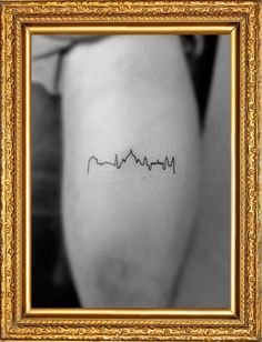 a black and white photo of a woman's arm with the word heartbeat on it