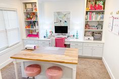 a desk with two stools in front of it