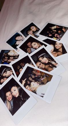 many polaroid photos are laying on the bed