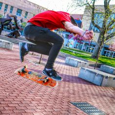 a skateboarder is doing a trick in the air on his skateboard outside