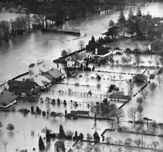 an aerial view of flood waters surrounding houses