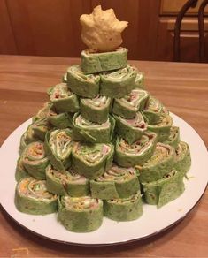 a christmas tree made out of rolls on a plate