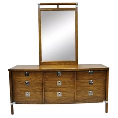 a wooden dresser with drawers and a mirror