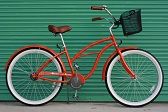 an orange bicycle parked in front of a green garage door