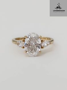 an oval diamond ring with three pear shaped diamonds