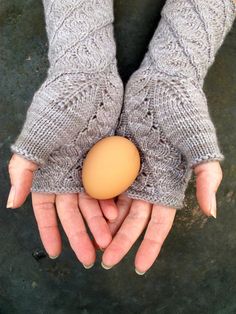 a woman's hands holding an egg in her left hand