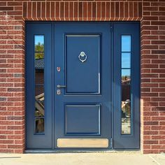 a blue front door on a brick building