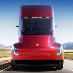 a red tesla semi truck driving down the road