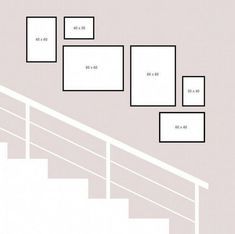 a set of stairs with white frames on the wall above it and below them is an area for numbers to be added