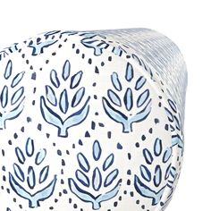 a blue and white patterned bean bag with trees on the front, sitting against a white background