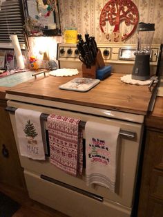 an oven with tea towels hanging from it's rack