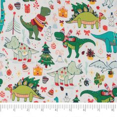 a white fabric with dinosaurs and christmas trees