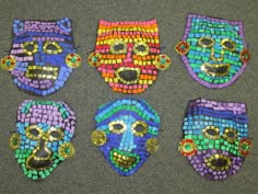 four masks made out of colorful mosaic tiles