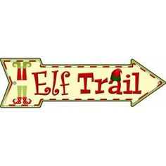 an arrow sign that says elf trail with boots and christmas stockings on the bottom of it